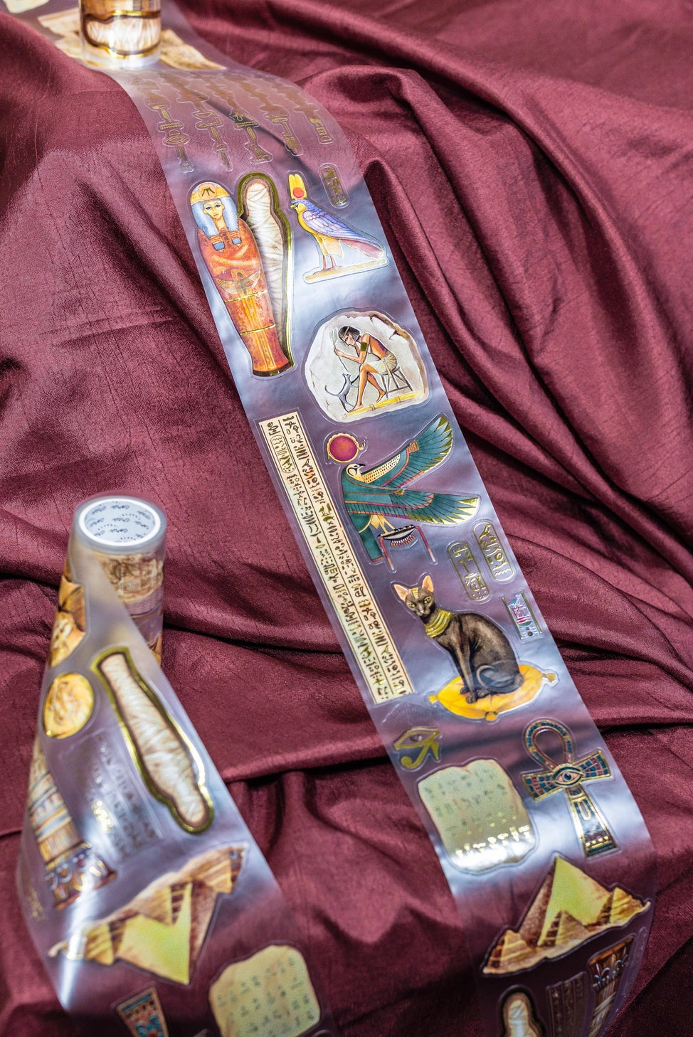 A unique extra large transparent tape design by CoraCreaCrafts. This tape features beautiful designs to transport you back in time to Ancient Egypt and the world of Pharaohs.Features: Super convenient, premium pre-cut designs, easy to peel off like stickers, beautiful gold foil detailing
Size: 10cm wide × 5m long with a 100cm repeat (that means you get 5 times 1 full meter of completely different designs!)
