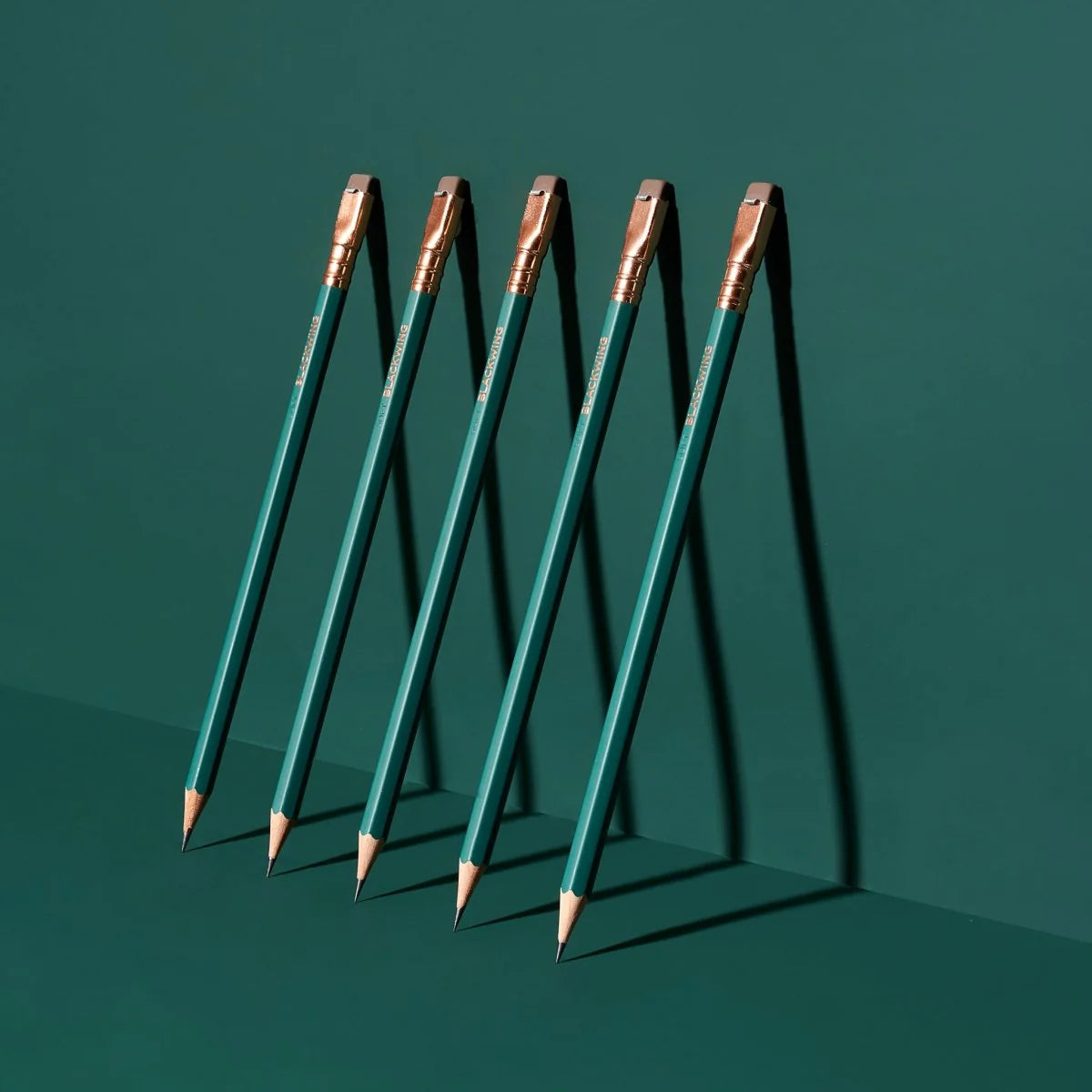 This colorway has a matte green finish, copper imprint, copper ferrule, and taupe eraser. It features a “SOFT” pencil graphite indicator stamp on the barrel. This Blackwing graphite pencil is ideal for musicians, woodworkers, artists, and anyone who prefers a soft, satisfying dark line. The Blackwing Matte pencil is the softest of the four popular core Blackwing models.
Blackwing Matte pencils come in a 12-pack gift box that also doubles as a pencil cup. The Blackwing Matte has the soft same pencil graphit