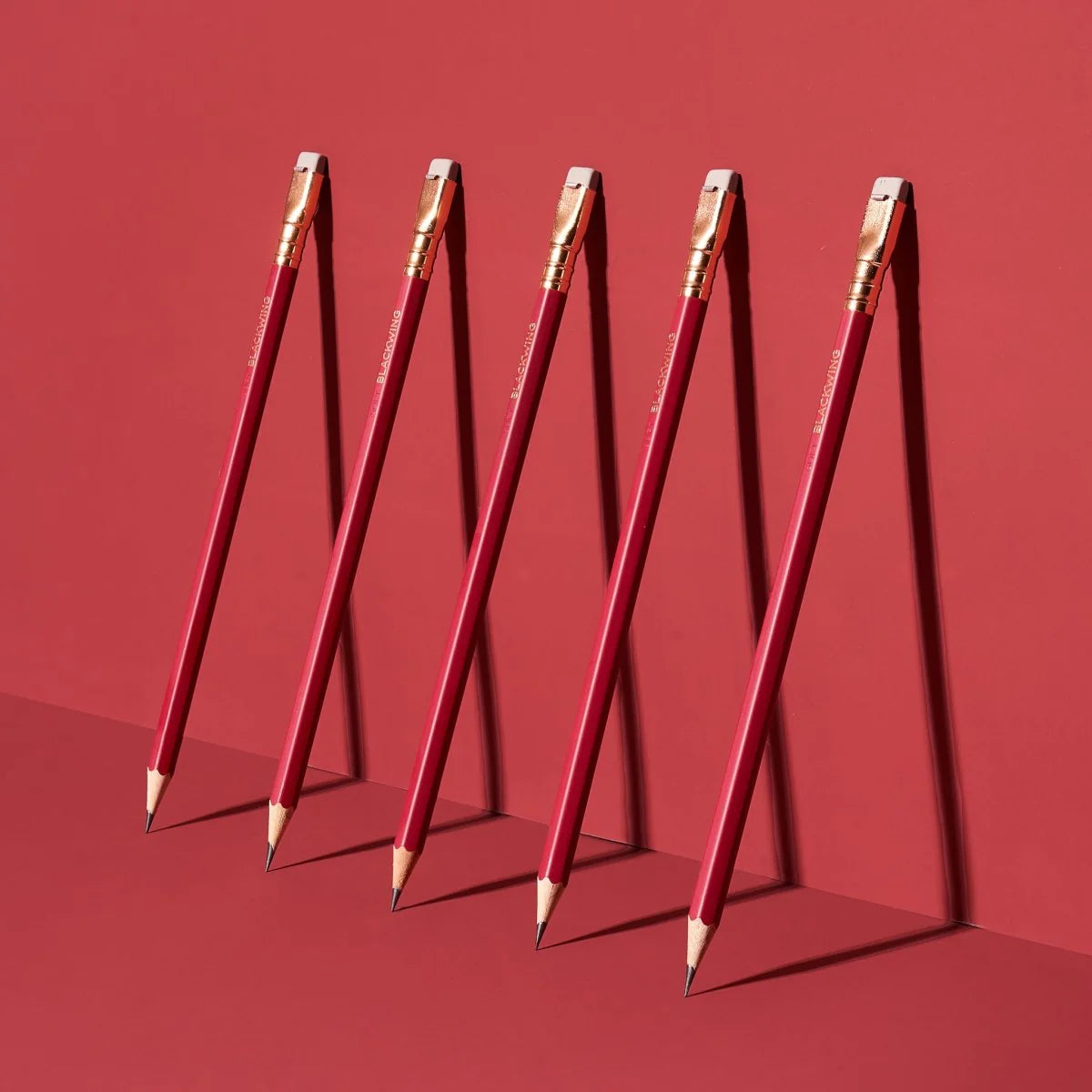 This colorway has a matte red finish, copper imprint, copper ferrule, and light gray eraser. It features a “SOFT” pencil graphite indicator stamp on the barrel. Not to be confused with our red core pencils, this is a graphite pencil with a red barrel. This pencil is ideal for musicians, woodworkers, and anyone who prefers a soft, dark graphite line. The Blackwing Matte is the softest of the four core Blackwing models.
Blackwing Matte pencils come in a 12-pack gift box that also doubles as a pencil cup. The