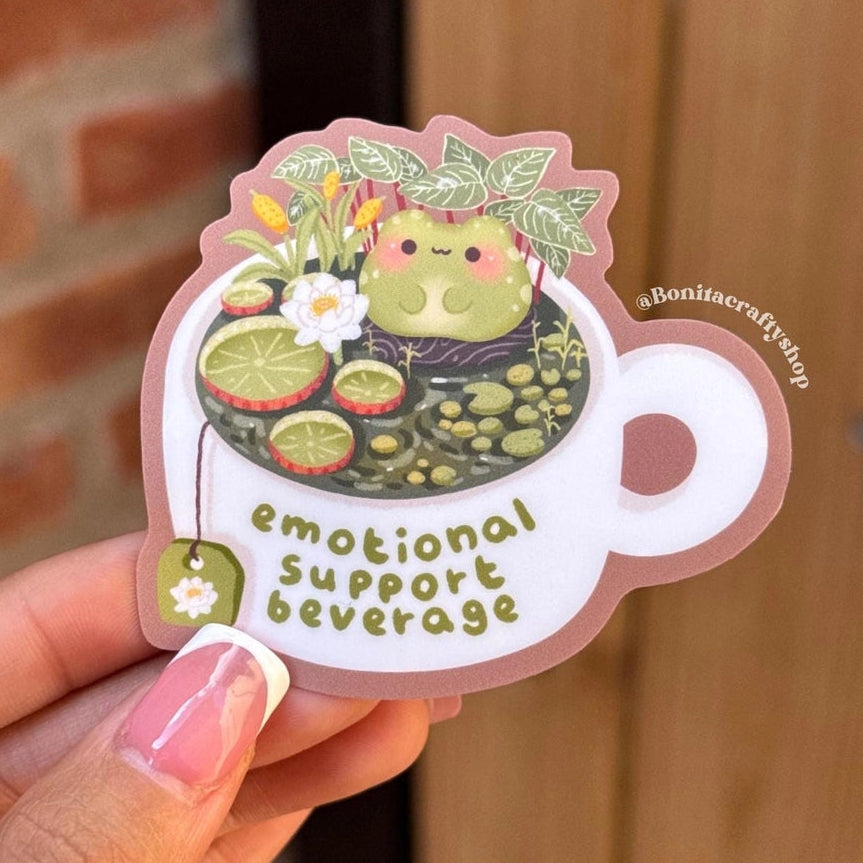 Bring some cozy comfort to your day with this “Emotional Support Beverage” frog sticker! Featuring a cute frog relaxing in a teacup pond surrounded by lily pads and flowers, this sticker is perfect for frog lovers, tea enthusiasts, and anyone who needs a little emotional support beverage energy.
♡ STICKER DETAILS ♡
~ Sticker size: 2.7’’ inches
~ Printed on matte sticker paper
~ Matte Laminate finish ✨
~ Scratch-resistant surface, water-resistant
~ ONLY Handwash. This sticker is not dishwasher or microwave