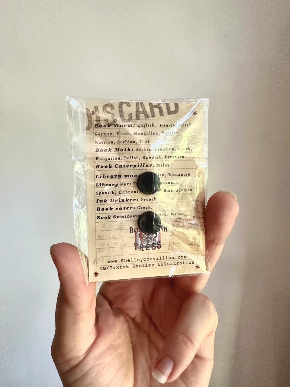 These pins are a lovely, small and cute piece to show off on your clothes, book bags, or wherever you show off your pins!
1.75 inches across, black metal lapel pin with "hard" enamel colors. Black rubber clasps. Packaged in a small plastic bag with a card backing.
"Are your customers book hoarders? No one loves a good horde like a dragon. And I love a good pun, so I combined the two into this Book Wyrm design! Wyrm is the old English word for dragon."