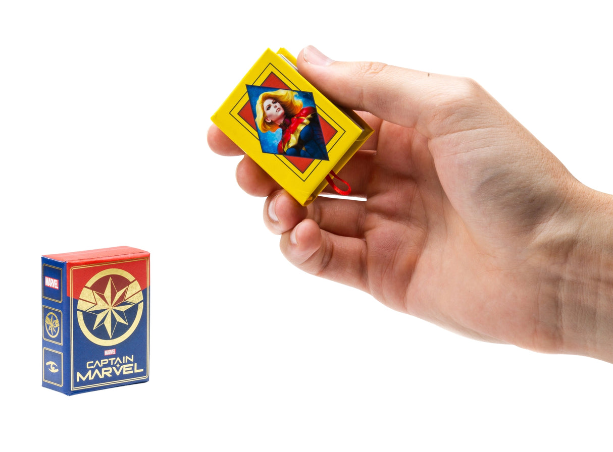 Carol Danvers, the super hero known to all as Captain Marvel, is one of the most powerful beings in the Marvel Universe. Now fans eager to learn more about her amazing adventures can follow her hero’s journey through the pages of this tiny storybook. Summarizing five decades of Captain Marvel’s comic book tales and featuring beautiful art from multiple eras, this unique collector’s item is the perfect gift for any Marvel fan!
AN EPIC SAGA IN THE PALM OF YOUR HAND: Covering 50 years of Captain Marvel’s hero