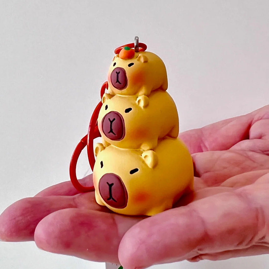 This adorable keychain adds personality wherever you go, whether clipped to your keys, bag, or backpack. Cute, lightweight, and easy to gift, it’s perfect for anyone who loves whimsical accessories or capybara-themed goodies.
Approx 2in x 2in
Includes 1 keychain 