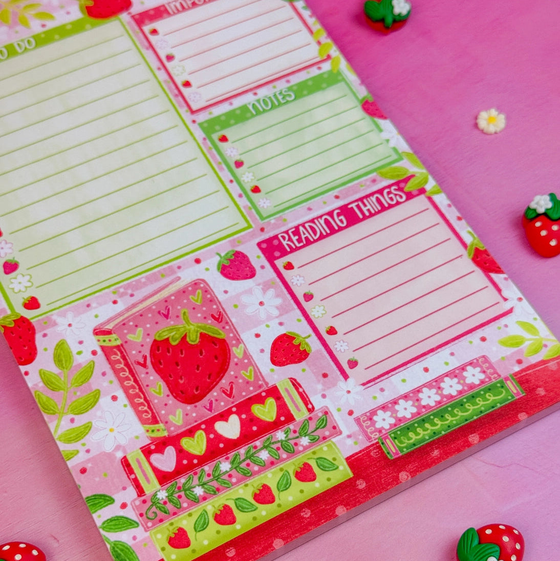 Stay organized in style with this adorable Strawberry Book Stack Daily Planner Notepad! Perfect for jotting down your daily tasks, goals, and bookish ideas, this notepads brings a pop of personality to your desk. Featuring a sturdy cardboard back and premium 70lb. uncoated paper, it's built to last through all your planning adventures.
✦ DETAILS ✦
Size: 5.5" x 8.5"
70 lb. Paper Uncoated
Padded With Cardboard Back
50 Sheets
No magnet backing