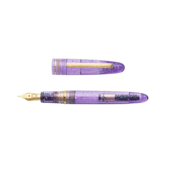 Esterbrook x Sakuradragon Sakura Street Estie Fountain Pen
Created with artist Cindy Duong of Sakuradragon, the Sakura Street Estie brings her imaginative illustrated world to Esterbrook's traditional Estie fountain pen. Its U.S.-blended material combines translucent purple with colorful glitter sparkle, while the custom clip is etched with Cindy's Sakura pattern. Dual Esterbrook and Sakuradragon engraving and a gold-plated converter finish the design. Each pen arrives in special packaging with Japanese gi