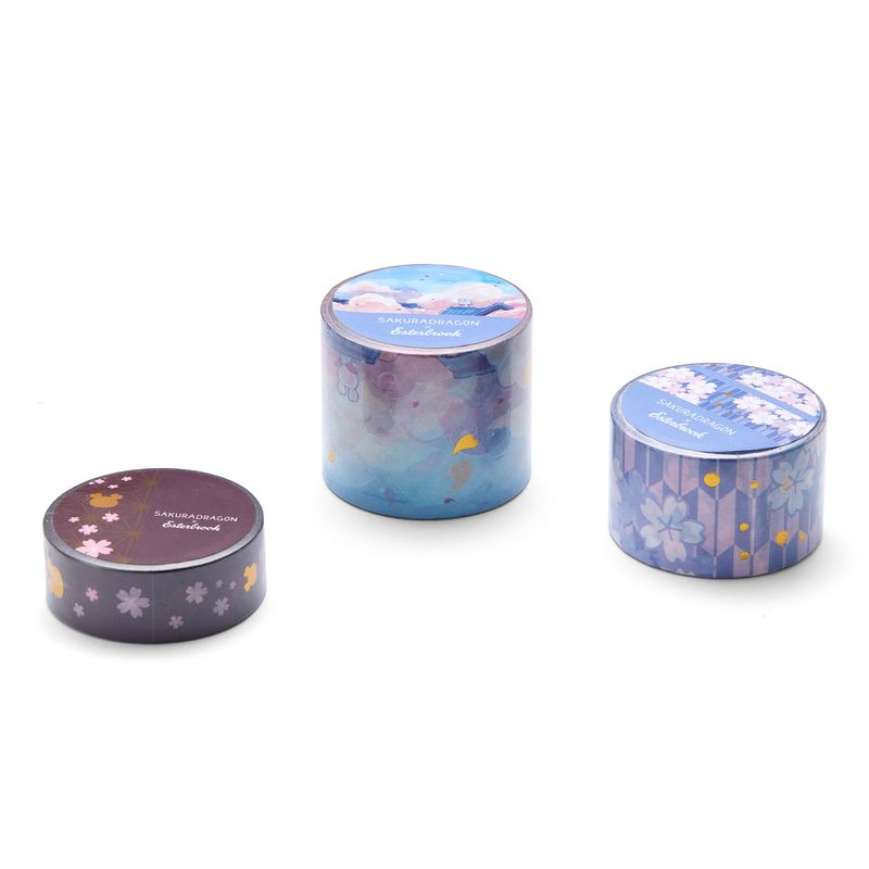 Esterbrook x Sakuradragon Washi Tape - Sky
The Sky Washi Tape turns Cindy Duong's Sakura Street Sky illustration into a continuous scene. Soft clouds and rooftops fill the 3.5 cm-wide tape, with gold foil details appearing throughout the design. Each roll contains five meters for decorating journals, letters, and stationery projects. 