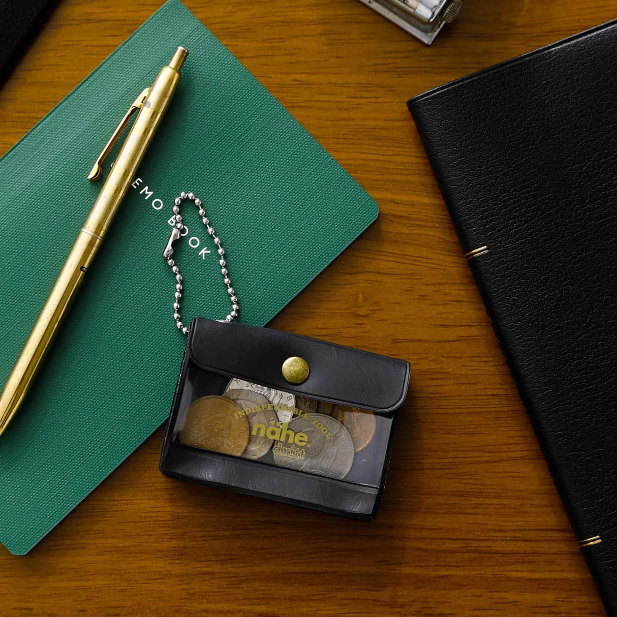 A miniature keychain version of the popular General Purpose Case by nähe. The true-to-original case comes with a clear front pocket with extra inserts inside and out. A ball chain securely attached to the corner of the case lets you hang it onto your keys or bags, perhaps in multiples.
Perfect size to travel with and quickly access your keys, coins, medicine, or small accessories. 