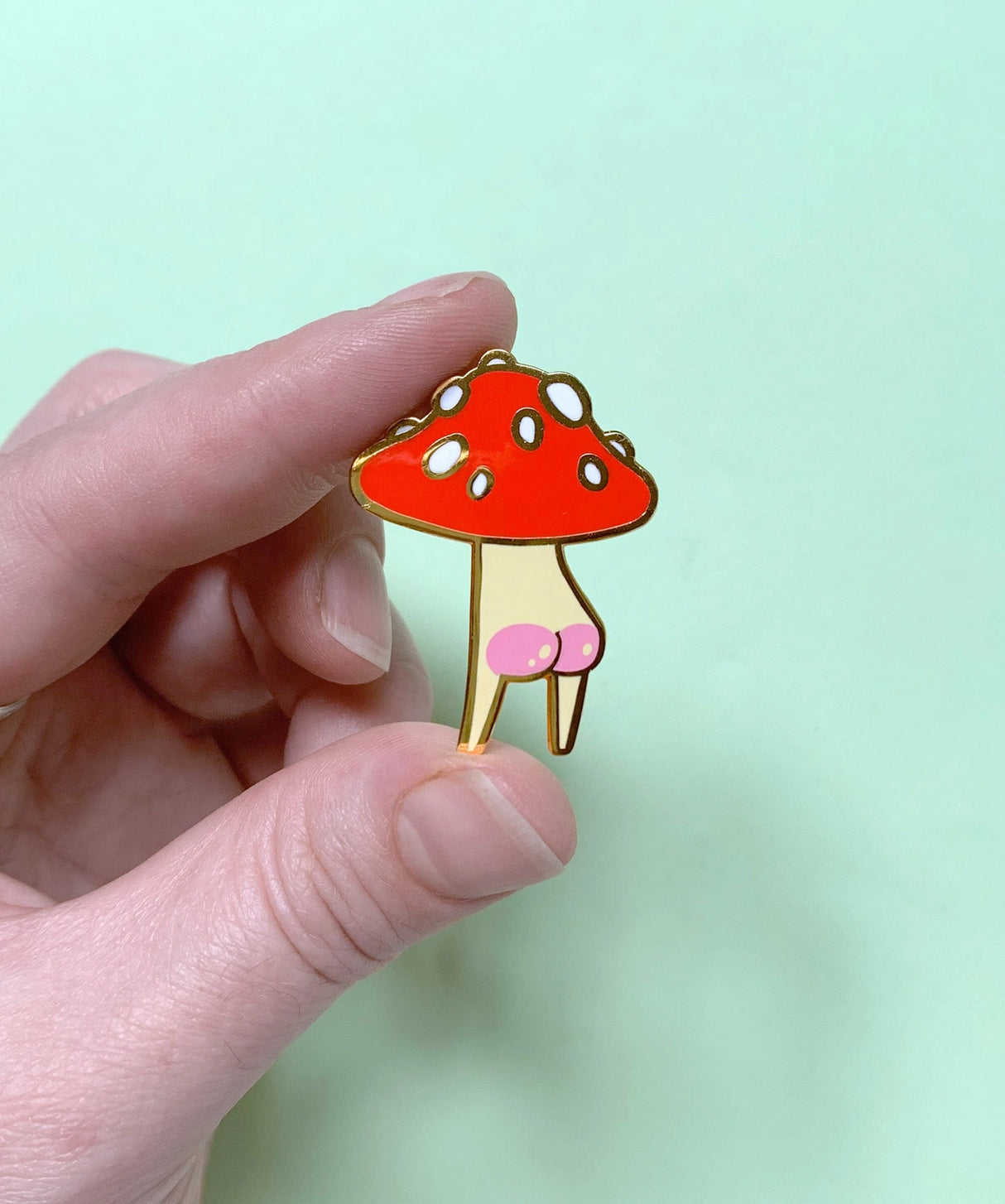Booty Mush enamel Pin measures 2.6 x 3.5cm, made from red, cream and white hard enamel with shiny gold metal finish and pink screen-printed rosy bum cheek details.
This pin is held in place with secure rubber backing. Comes on a 100% post-consumer recycled backing card.
Designed in Melbourne by Hannakin.