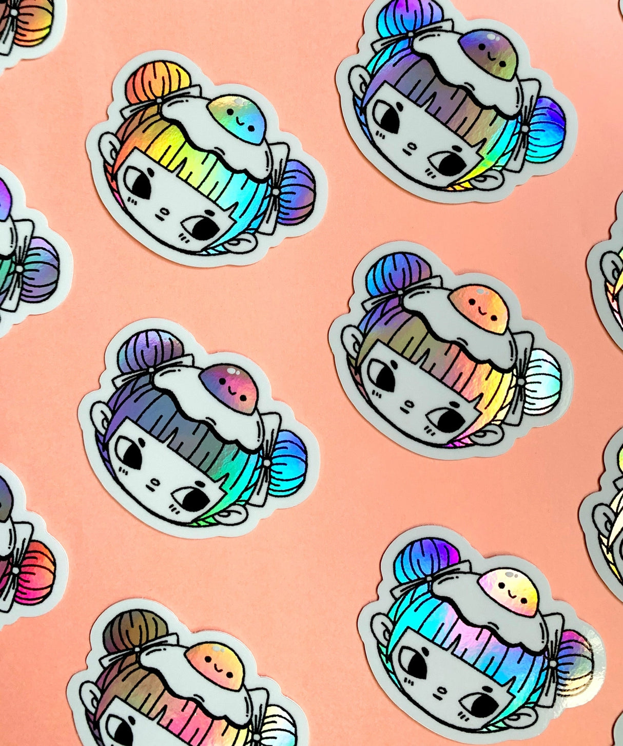 "Egg Buns" Vinyl Sticker made from Hannakin illustration with holographic accents (hair and egg yolk) and shiny gloss finish.
Made from a durable waterproof vinyl with a matte laminate that protects it from scratching, rain and sunlight.