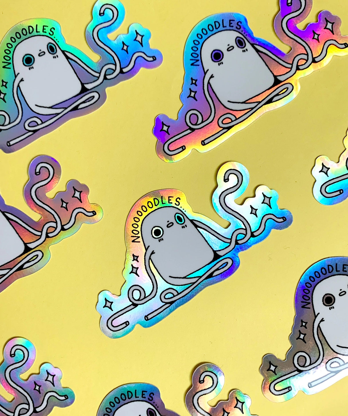 "Noodles" Vinyl Sticker made from Hannakin illustration with holographic accents (background) and shiny gloss finish.
Made from a durable waterproof vinyl with a matte laminate that protects it from scratching, rain and sunlight.