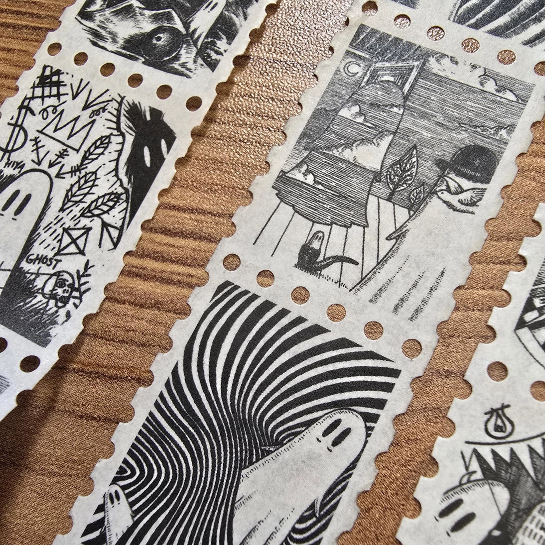 The second of two tapes from the Creative Spirits series by Jon Turner, little ghosties taking you on an eclectic tour of art history. This roll features ghosts inspired by Bridget Riley, Rene Magritte, Hilma Af Klimt, Georgia O'Keeffe, Salvador Dali, Paul Cezanne, Pablo Picasso, Georges Seurat, MC Escher, and Jean-Michel Basquiat.
Perforated to look like a roll of postage stamps, this washi tape features a repeating pattern of ten designs in portrait format from hand-drawn pen and ink artwork, recreated i