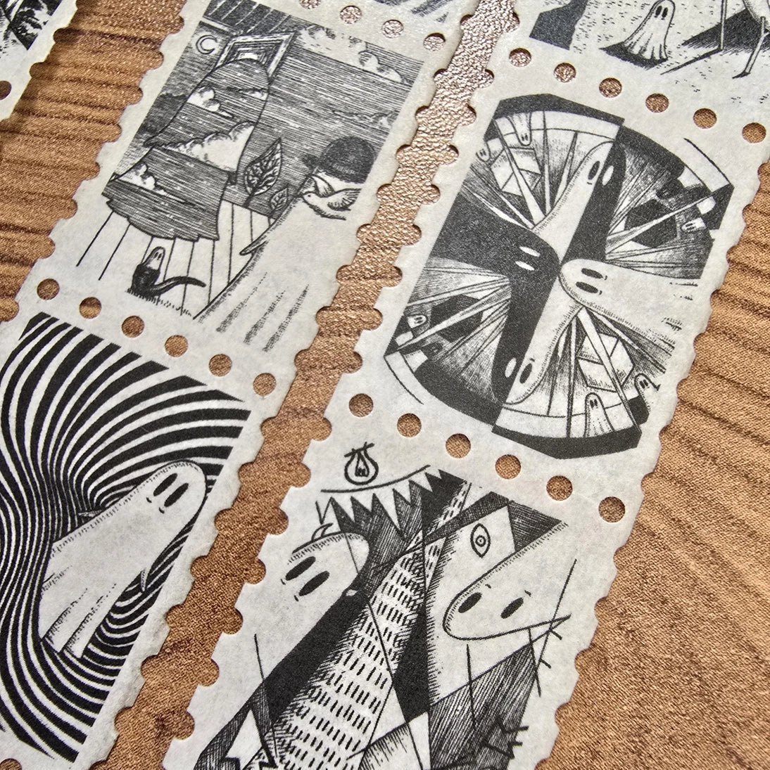 The second of two tapes from the Creative Spirits series by Jon Turner, little ghosties taking you on an eclectic tour of art history. This roll features ghosts inspired by Bridget Riley, Rene Magritte, Hilma Af Klimt, Georgia O'Keeffe, Salvador Dali, Paul Cezanne, Pablo Picasso, Georges Seurat, MC Escher, and Jean-Michel Basquiat.
Perforated to look like a roll of postage stamps, this washi tape features a repeating pattern of ten designs in portrait format from hand-drawn pen and ink artwork, recreated i