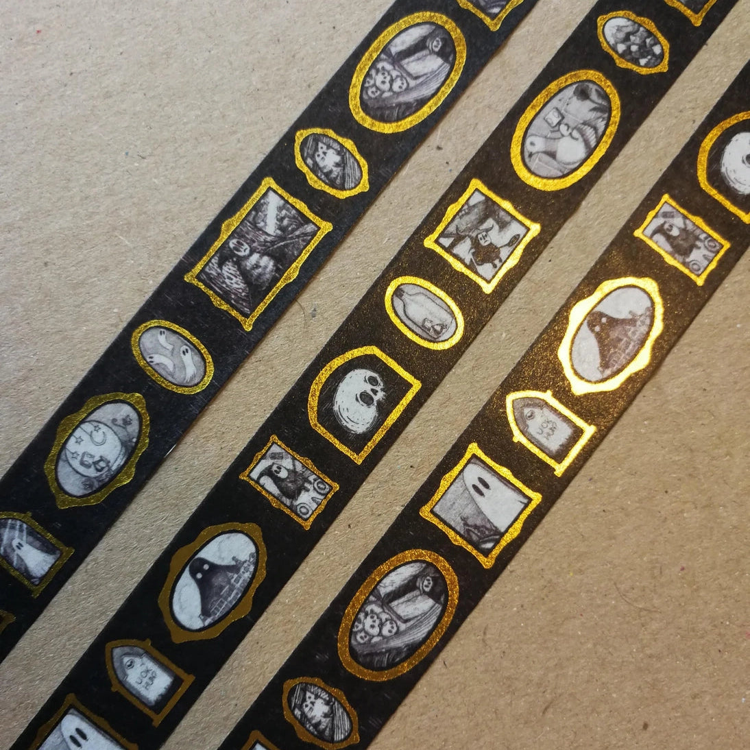 Turn every surface into a tiny gallery with this washi tape featuring tiny Jon Turner artworks in shiny gold frames, an array of little robots, ghosts and other spooky oddities. Perfect for spooky journalling or curious correspondence.
Two designs available, with each tape featuring 16 miniature masterpieces in a repeating pattern. Each roll measures approximately 15mm wide, and the roll is 10m long; they are cello wrapped and decorated with branded stickers on either side.
15mm wide
10m length