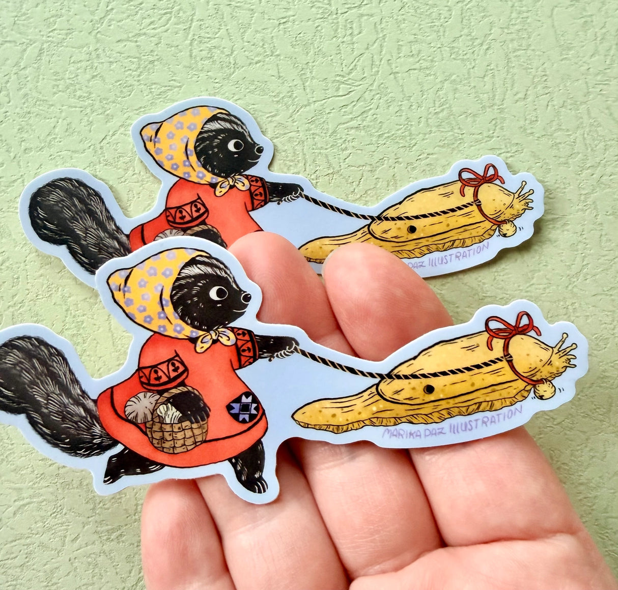 This Skunk and Slug are going for a walk.
This vinyl matte sticker is weather and waterproof-stick it on a notebook, bike, or car- it's going to stick around! Heck, throw it on a water bottle and through the dishwasher. This sticker can go anywhere. Sticker measures 4.74" x 2.75" Printed in USA.