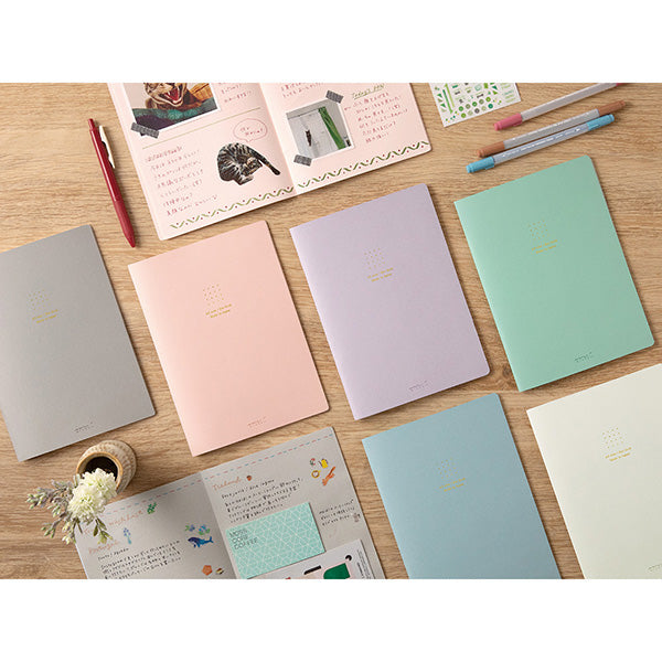 Stitcher-bound notebook for casual use. The inner paper is made of paper that matches the cover, so you can enjoy your favorite paper and pen color combination.
The popular 5mm dot graph inner paper is "MD paper" that is easy to write on regardless of pen. The dot grid serves as a subtle guide when writing letters and illustrations, and makes it easier to apply stickers and photos neatly.
A calm design that is easy for adults to hold. The dull color cover has a discreet foil stamping p