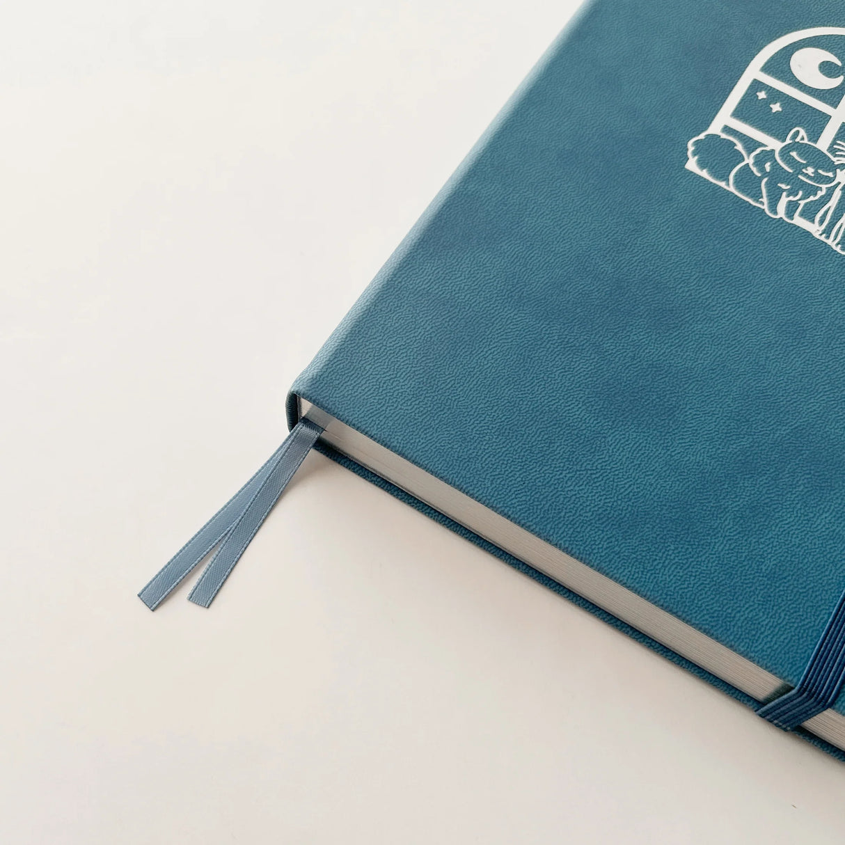 Jiji The Cat Journal in Ocean Blue with Holographic Edges and Logo 🌊✨
Product Details:
Size: A5 (5.70 x 8.26 inches)
160 Dotted Grid Pages (5 x 5 mm)
2 Bookmarks
Elastic Band and Pen Holder
Expandable storage compartment