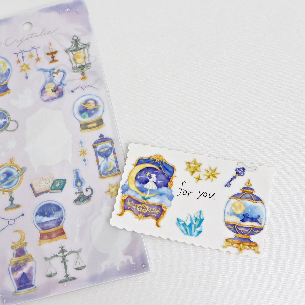 This is an illustration sticker that traps a fantasy world view and motif in a glass container like a snow globe or terrarium. It is a sparkling hologram specification.
• This package includes 1 sheet of sticker
• Material: Transparent PET Hologram Lamination
• Package measures approx. H202 x W93 x D1mm
• Made in Japan
