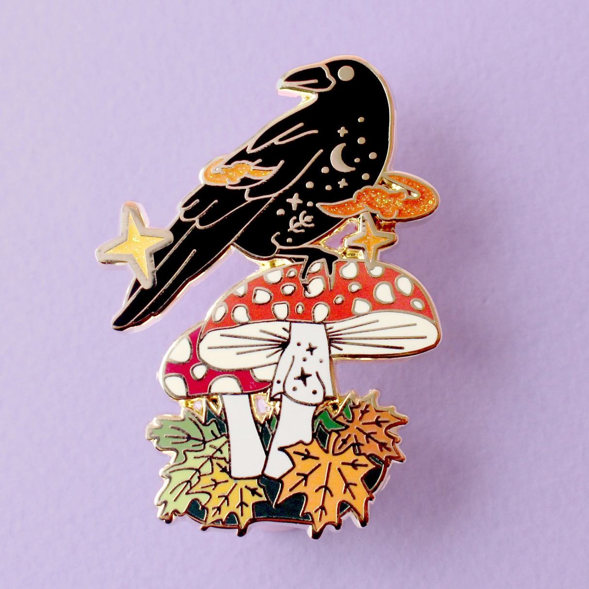 This enamel pin features Crow sitting a fall mushroom, surrounded by mystical orange smoke. The pin is presented on a Glitter Punk backing card and is secured with 2 pin backs.
This pin is part of the Corvid Collection, an 8-part series of bird pins.
Measurements: 46mm