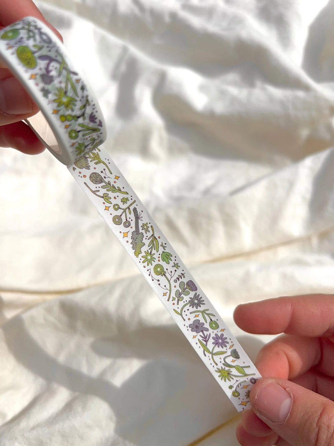 This washi tape features fluid green and purple flowers dancing loosely around to create an energetic, yet soft tape.
This roll is 15mm wide x 10m of paper tape. Washi tape is super durable and flexible. It tears easily and can be safely applied to a variety of surfaces; it doesn’t leave a sticky residue behind, making it especially ideal for stationery and hanging prints temporarily.