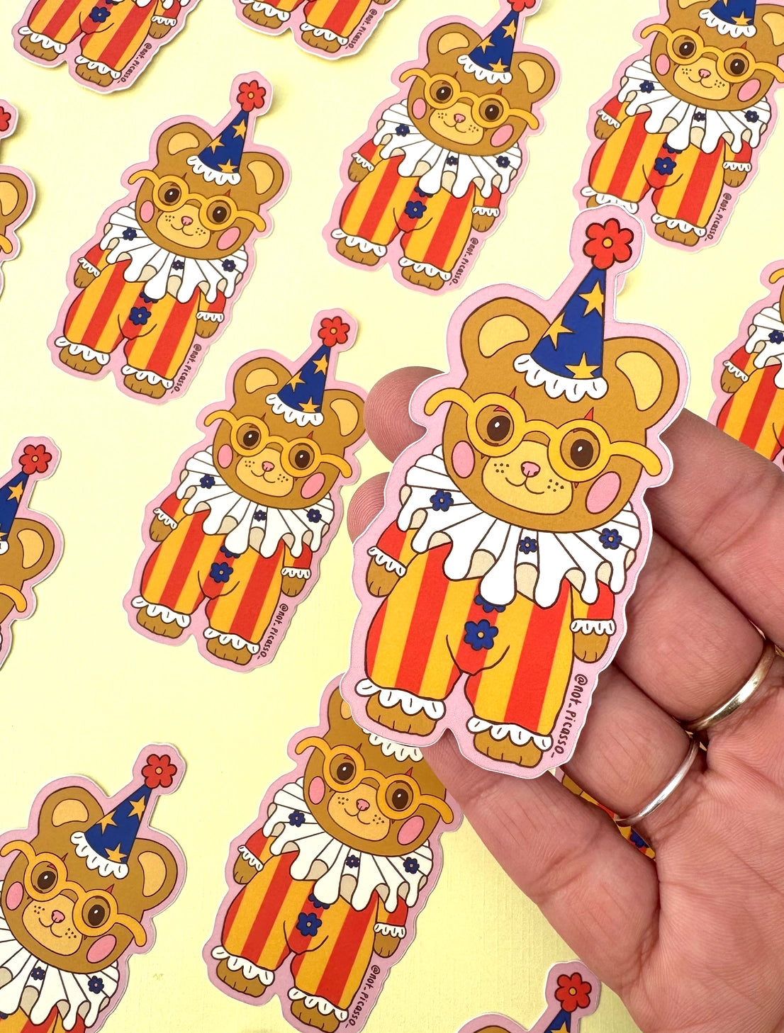 These adorable stickers feature a cute little bear in a clown suit.
These matte vinyl stickers feature an original design and are water, weather, and scratch proof. Perfect for putting on water bottles, computers or just about anywhere else.