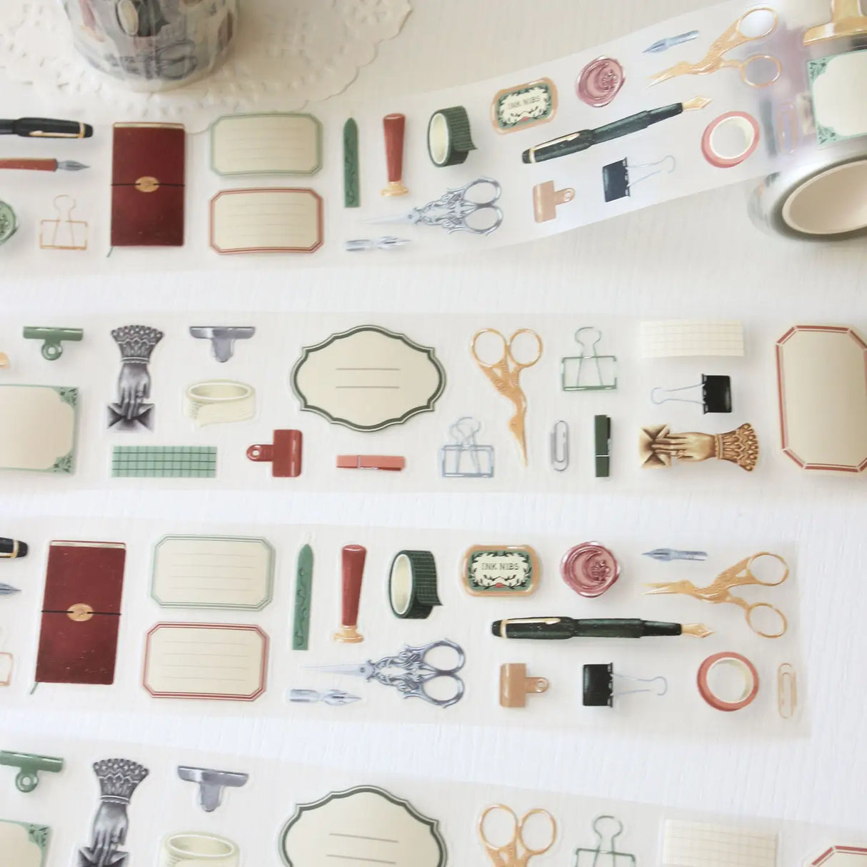 An updated version of our Stationery Essentials PET tape, now with a longer 50cm designer loop for even more creative possibilities.
This PET tape features hand-painted illustrations of vintage stationery such as wax seal stamps, fountain pens and ornate scissors. Designed by Rebecca and pre-cut for effortless use, it's perfect for journaling, collaging and adding a vintage aesthetic to any creative project.
Extra wide at 50mm with a matt transparent finish that layers cleanly over any background. No scis
