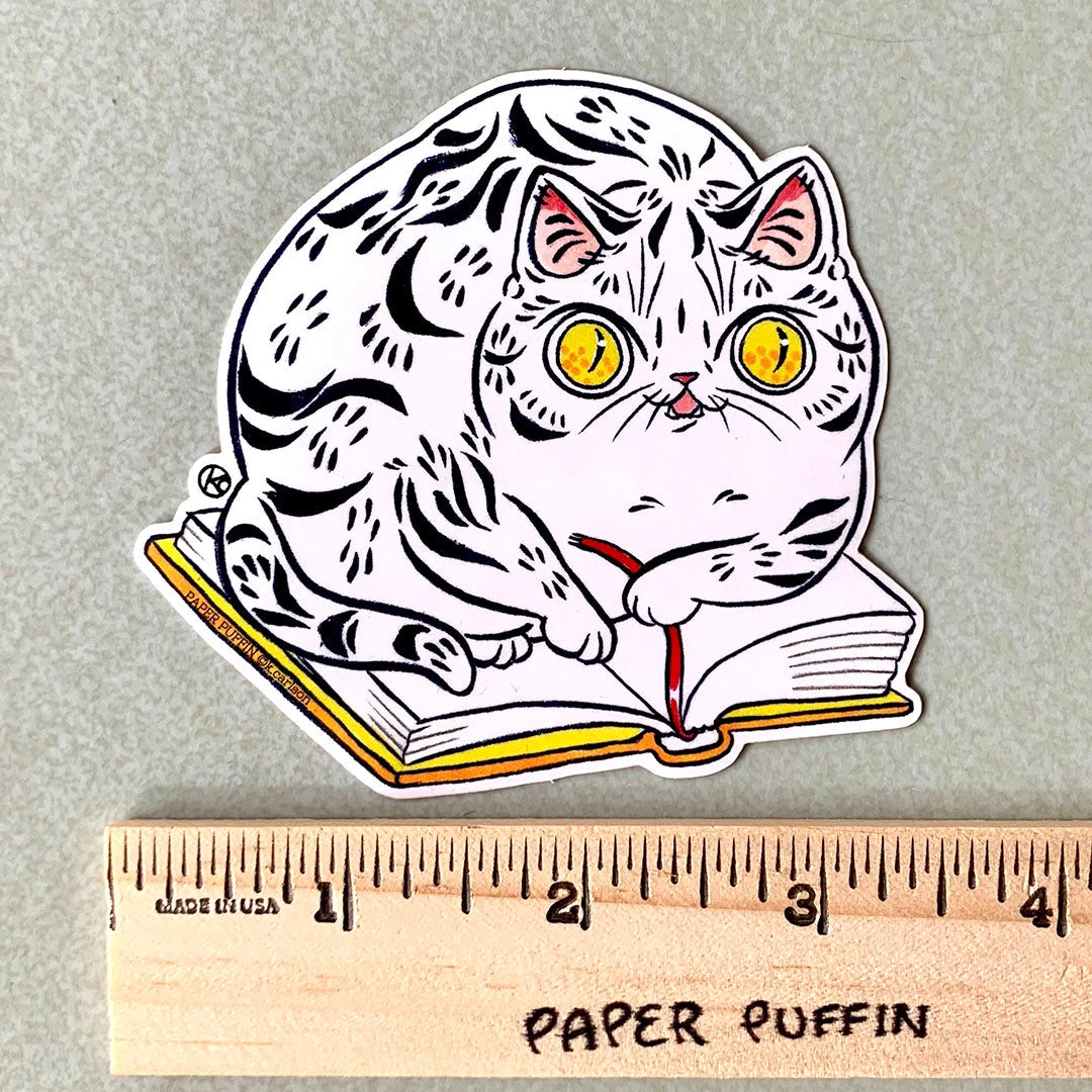 A cat sitting on a favorite book, helping you keep your spot.
+ size:3.3" x 3.4”
+ permanent adhesive glossy vinyl sticker with solid peel backing
+ scratch and weather resistant material, PVC free
+ packaged and shipped flat
All work and photos ©PAPER PUFFIN Art by. K.CARLSON