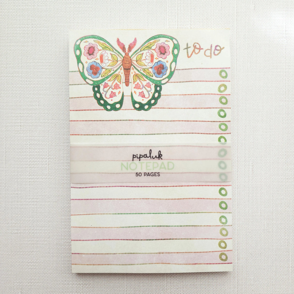 In the gardens of Wildflower Woods, a butterfly drifts from bloom to bloom, wings patterned with flowers gathered along the way. This notepad brings that light, floral moment to your desk, making everyday lists feel a little more inviting.
Designed to be practical without feeling busy, this notepad offers a simple, cheerful way to keep track of daily to-do lists and planning.