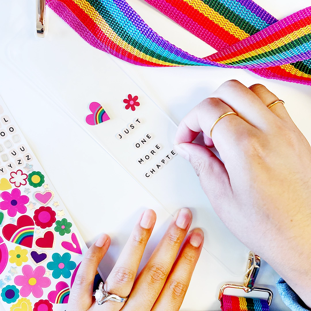Take your current read anywhere! This rainbow strap turns your favorite book or journal into an instant crossbody so you can read on the go, hands-free and in style. Perfect for book lovers, travelers, and sticker-covered notebooks alike!