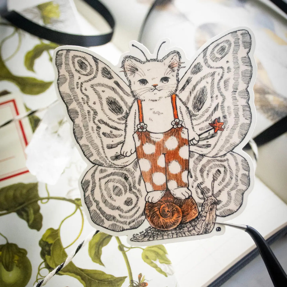 A whimsical fairy has come to grace our presence with its enchanting attire and slug partner! Illustrated in a whimsical pen-and-ink style with a soft vintage touch, “Fairy” brings a magical charm and a smile wherever it goes. Printed on durable white vinyl, this sticker is waterproof, UV-proof, and long-lasting — perfect for decorating water bottles, laptops, journals, or anywhere a touch of magic is needed.