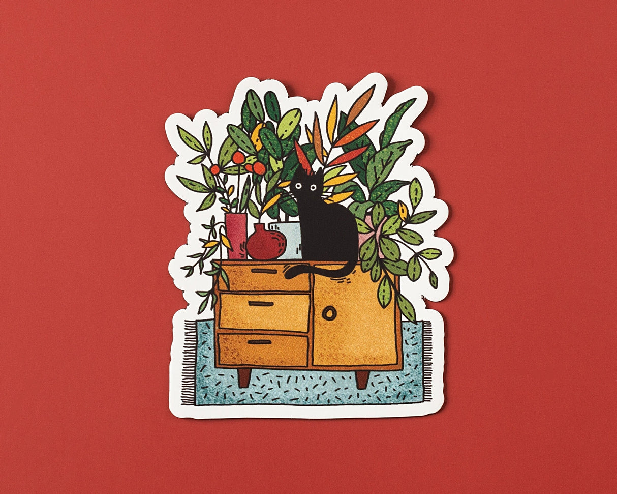 A cozy illustrated vinyl sticker featuring a curious black cat surrounded by lush houseplants and warm, homey details. Perfect for plant lovers, cat people, and anyone who enjoys calm, playful artwork.
🌟 Key Features:
• Dimensions: 3 x 2.5 inches
• High-quality vinyl material
• Waterproof and weather-resistant
• Ideal for personalizing any surface