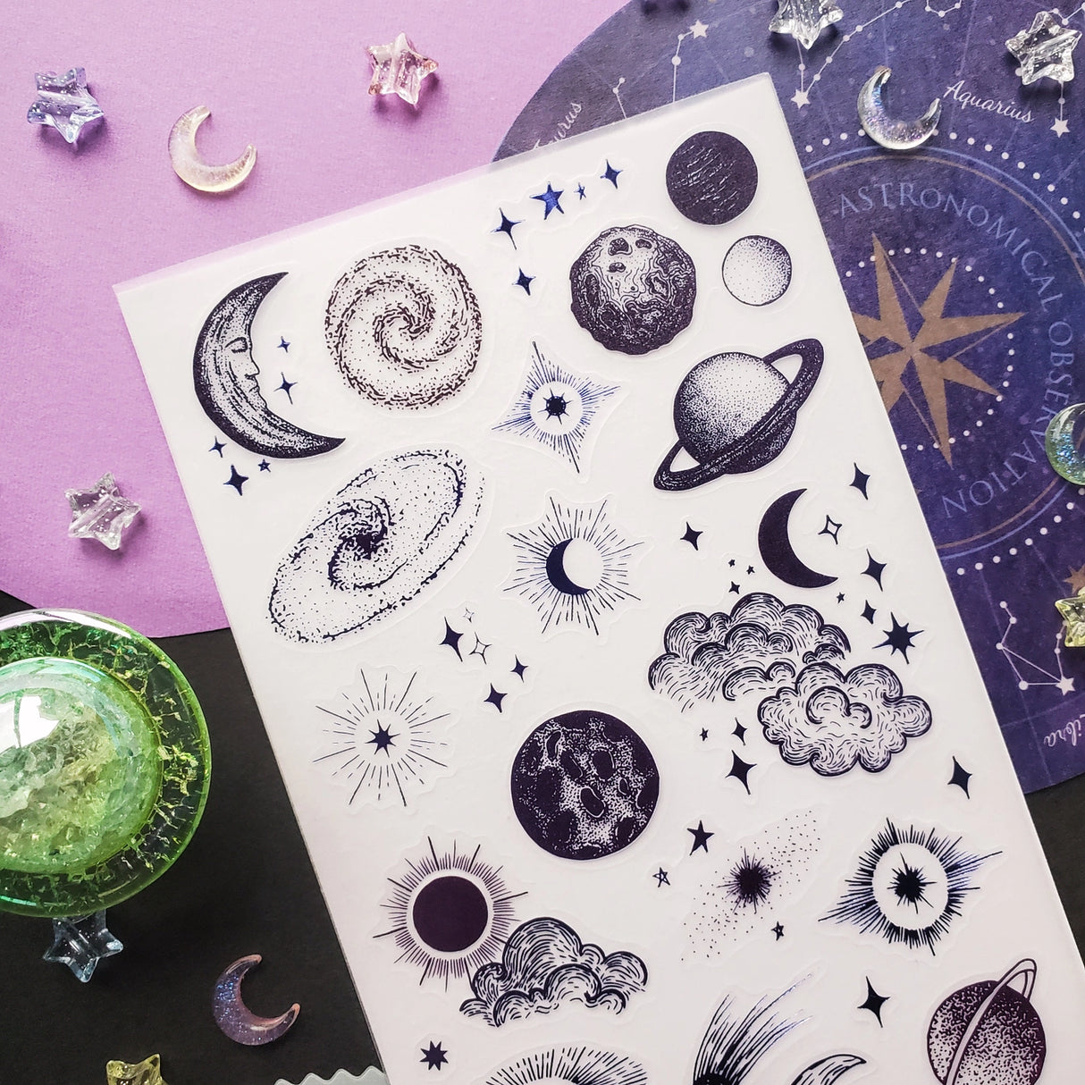 🌞🌙 Blast off into a universe of bold stars, swirling galaxies, and glowing celestial wonders! This cosmic collection is packed with suns that shimmer, moons that glow, and starbursts that practically hum with energy. With textured details and punchy pops of purple, every design feels like a little spark pulled straight from the night sky. Perfect for sprinkling a little cosmic magic wherever you want your pages to shine ✨
