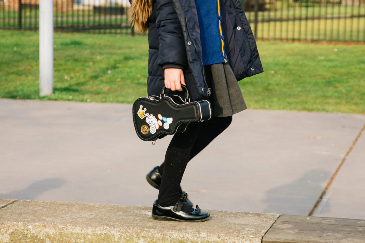 Lunch just got loud. This guitar-shaped tin lunchbox brings rock-n-roll attitude to school, work, or picnics. Keep sandwiches and snacks secure with a sturdy latch and carry handle, then personalise your case with the included set of stickers – just like a real tour pro. Made from durable, food-grade tin and designed to last, it’s the coolest way to carry your lunch on the road.