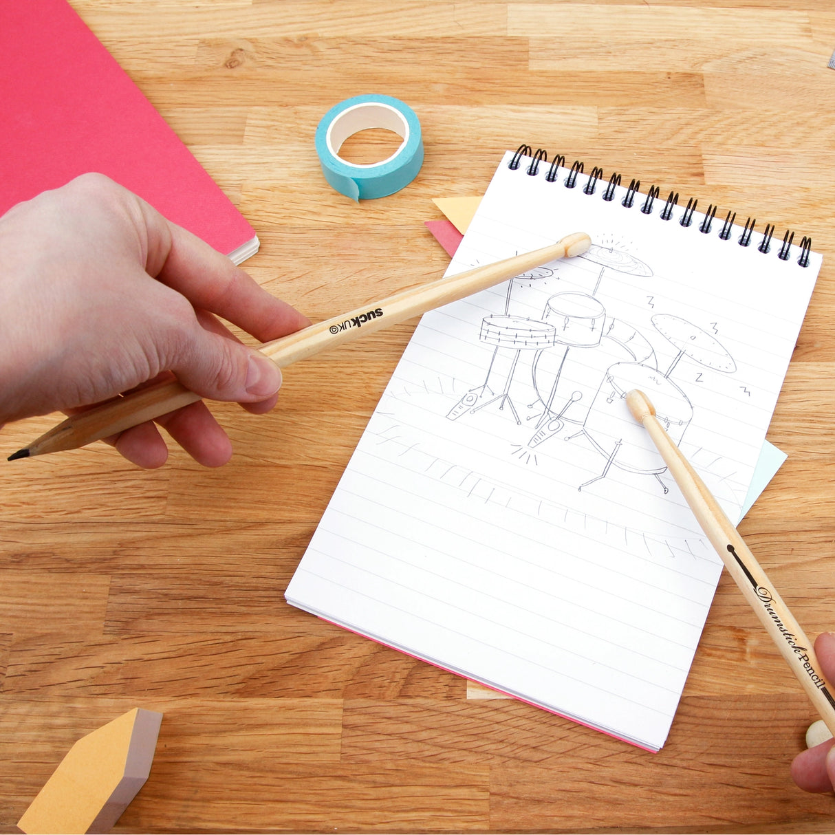 SUCK UK Drumstick Pencils
Some ideas arrive quietly. Others arrive in the middle of a drum break. Whether you're composing a rock-balled or just avoiding maths homework, drumstick pencils are always ready for an impromptu drum solo on the rim of your mug. Tap your way through the day with a pair of drumsticks that occasionally double as pencils. An ideal gift for fidgety creative thinkers.
Pair of pencils shaped like drumsticks.
Made from responsibly sourced wood.
Quiet alternative to a full-size drum kit