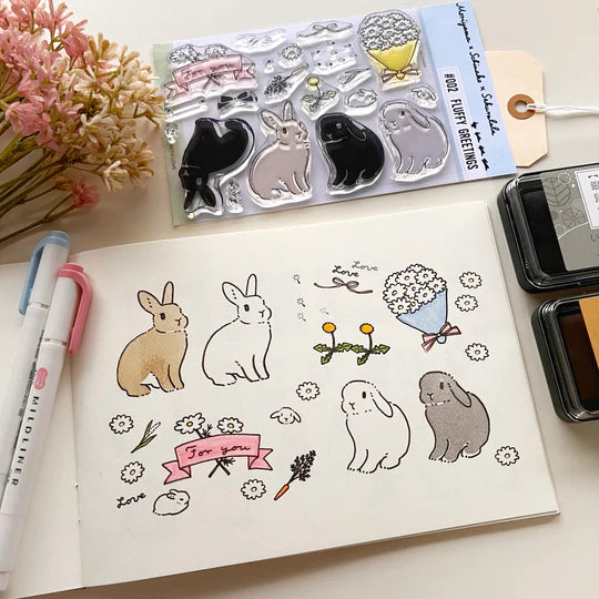 This collaboration with Moriyama, who has a wonderful shop in Ota Ward, Tokyo, and Shiko Moriyama, an illustrator who draws adorable rabbits.
"Fluffy Greetings" is a clear stamp that allows you to make rabbit cards. Since it is a large stamp, it can be printed in a notebook or journal as a cute accent. The stamps of the two large rabbits are divided into a base outline stamp and a coloring stamp that serves as a pattern.