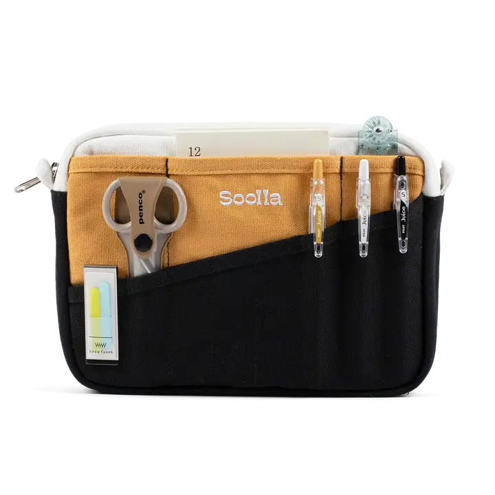 A compact carry-all pouch for artists, makers, and stationary lovers who appreciate a little order in their chaos. Structured enough to hold its form, soft enough to fit anywhere, and fully machine-washable for the days that get a little messy — your tools, pens, and creative essentials stay safe, visible, and ready wherever you go.
Inside, 20 pockets make space for art supplies, stationary essentials, and an A5 notebook, all secured by a smooth YKK zipper. Sized to fit within larger bags or carry on its o