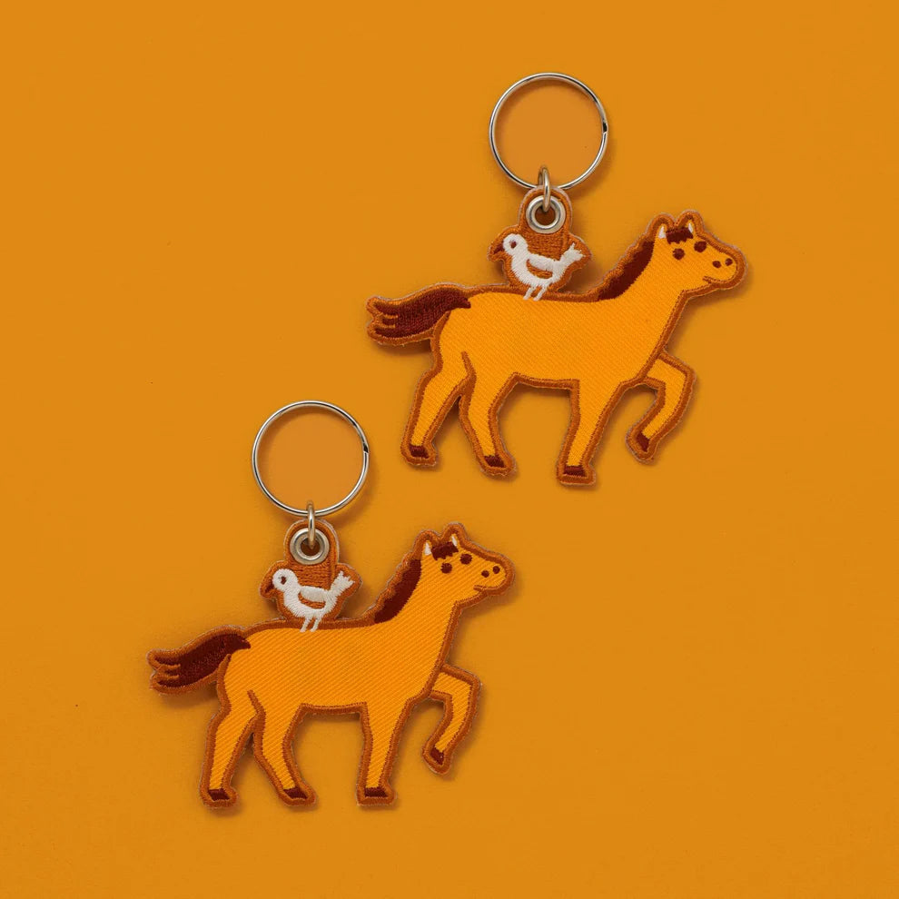 An embroidery keychain featuring the Horse which is the seventh sign of the Chinese zodiac. The horse symbolizes vitality and bold changes. Get lucky to use it as a keychain and a tag for your planner. LNY is February 17th this year!
A little bird perched atop on the brown horse adds a charming accent. The back side is embroidered with the word "uma" in hiragana, meaning a horse in Japanese. 