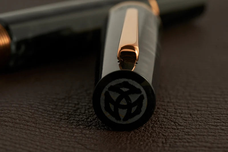 This TWSBI Obsidian fountain pen is made of a dark grey/black swirled acrylic resin, inspired by the natural obsidian stone. The pen is complemented by rose gold-plated trim and is equipped with a rose gold-plated stainless-steel nib.
Pen cap is able to post onto the back of the pen
Piston Filler Fountain pen.
Simply unscrew the end cap, dip into ink, screw back the end cap, and you're done! Ready to write!!