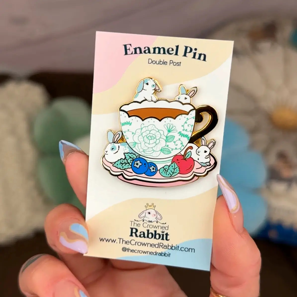 These pastel bunnies are spending a relaxing day amongst blueberries, cherries, and yummy tea inside an intricately decorated cup.
✦ Hard enamel
✦ Shiny gold metal
✦ 1.75 inches
✦ 2 Posts for extra security
✦ Rubber backings
✦ Back stamped for authenticity
Comes packaged on a backing card.