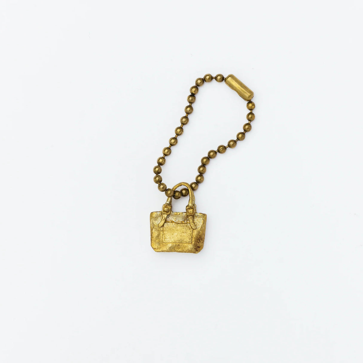 Brass charm in the shape of an engineer tote bag.
Equipped with a sleek ball chain, it attaches effortlessly to your bags, pouches, or key rings. Despite its petite size, it brings the distinct, rich texture and unmistakable presence that only genuine brass can provide.
As you use it, the brass will develop a natural patina over time—enjoy the changing character that comes with age.
Color: The color you see on your screen may differ from the actual product.
Brass Products
Due to the nature of brass, so