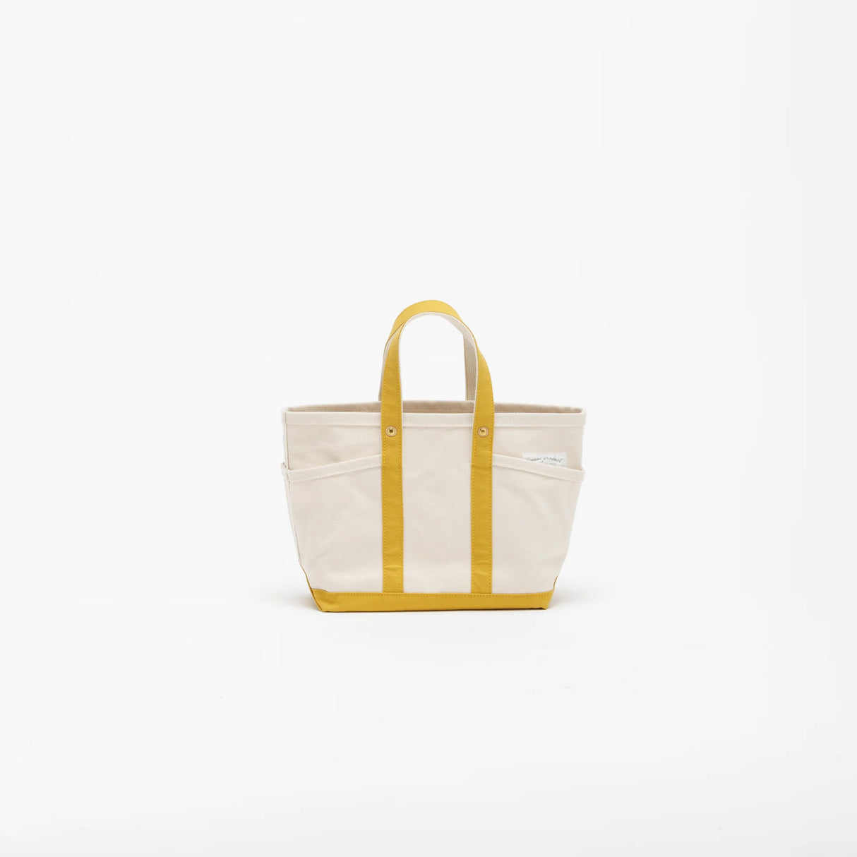 The SUPERIOR LABOR Mini Tote Bag
A simple, timeless canvas bag designed for everyday life.
Its compact size is just right for daily essentials, while the four outer pockets keep your glasses, keys, favorite pens, or notebook neatly organized.
They make it easy to stay tidy and add a touch of extra storage without changing the clean look of the bag.
Size: W37×H23.5×D12.5cm
Canvas Products
Painted areas may be affected by friction or water, which can cause color transfer. Please handle with care.