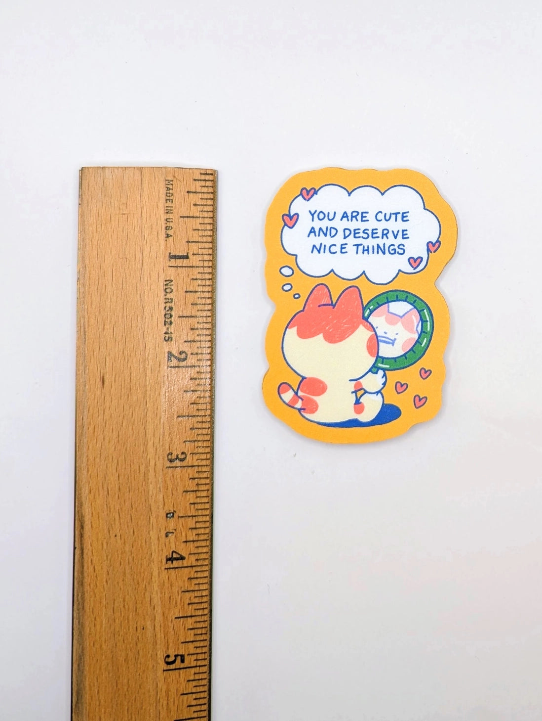 Give yourself (or a friend) a little daily boost with this "You Are Cute and Deserve Nice Things" vinyl sticker! Featuring an adorable chubby cat gazing into a mirror with a sweet self-affirming message, this sticker is the perfect reminder to practice self-love and kindness. The warm, cozy color palette and playful design make it an uplifting addition to your laptop, water bottle, journal, phone case, or anywhere you need a dose of encouragement.