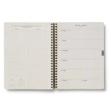 This extended, 17-month version of our softcover spiral planner features a printed bookcloth cover with gold foil detailing. In addition to weekly and monthly views, the planner includes space for weekly notes, a list of celebrations, and pockets for storage.&nbsp;

DETAILS

&nbsp;Printed in full color with foil stamped year
Natural white text paper interior
August 2026-December 2027
Monthly and weekly views
Space for notes for each week
List of celebrations
Pockets for storage
Spiral bound
6.25" W x 8.5" L