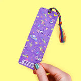 'Alien Abduction Bookmark by Turtle's Soup. Libraries beware! This nerdy alien is abducting every book in town! He loves reading the unique stories that fill planet Earth. His abduction beam has a wide range, so he might accidentally pick up some life forms as well. Hopefully, they don’t mind reading among the stars with him!

Hold your spot in style with our fun and funky bookmark collection! Whether you prefer romance, fantasy, or science fiction, our bookmarks will fit perfectly between the pages of your