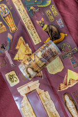 A unique extra large transparent tape design by CoraCreaCrafts. This tape features beautiful designs to transport you back in time to Ancient Egypt and the world of Pharaohs.Features: Super convenient, premium pre-cut designs, easy to peel off like stickers, beautiful gold foil detailing 
Size: 10cm wide × 5m long with a 100cm repeat (that means you get 5 times 1 full meter of completely different designs!)
