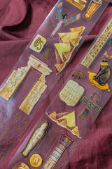 A unique extra large transparent tape design by CoraCreaCrafts. This tape features beautiful designs to transport you back in time to Ancient Egypt and the world of Pharaohs.Features: Super convenient, premium pre-cut designs, easy to peel off like stickers, beautiful gold foil detailing 
Size: 10cm wide × 5m long with a 100cm repeat (that means you get 5 times 1 full meter of completely different designs!)