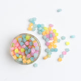 Archer and Olive - Glow in Dark Wax Seal Beads Halloween 2025-1 Pastel-colored beads in a clear jar on a white background