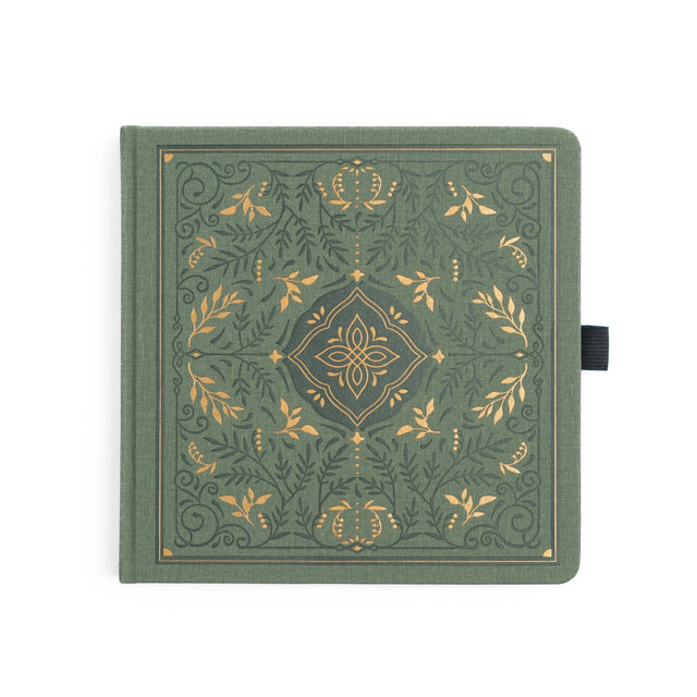 Introducing the Storybook Notebook, featuring an intricate full cover design inspired by vintage special edition books, part debossed and part hand stamped with gold foil on a vintage olive vegan leather cover. This design spans the full notebook, with special debossed and foiled details on the back cover, spine and front cover.