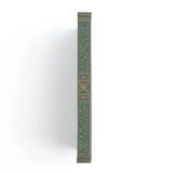 Introducing the Storybook Notebook, featuring an intricate full cover design inspired by vintage special edition books, part debossed and part hand stamped with gold foil on a vintage olive vegan leather cover. This design spans the full notebook, with special debossed and foiled details on the back cover, spine and front cover.