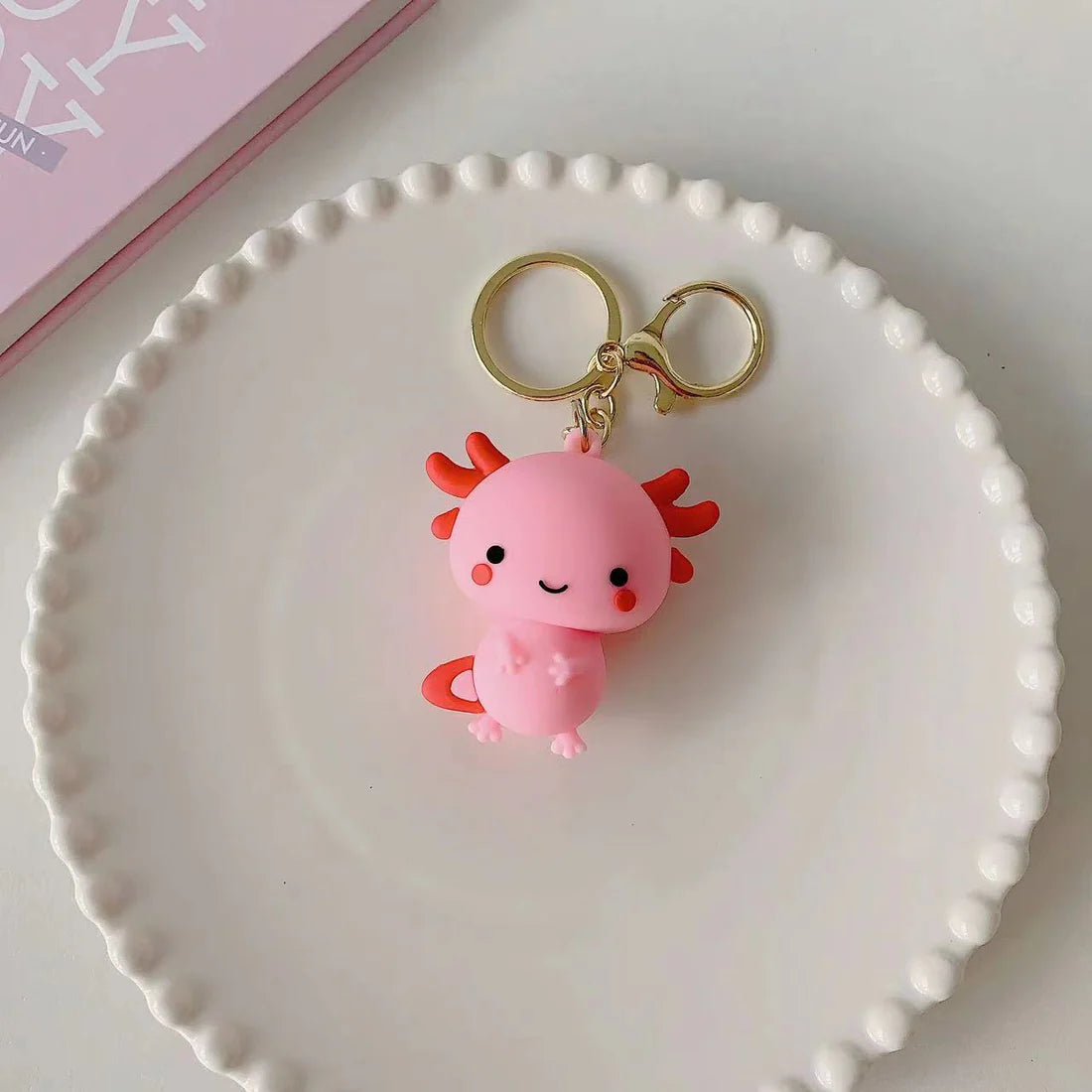 This adorable keychain adds personality wherever you go, whether clipped to your keys, bag, or backpack. Cute, lightweight, and easy to gift, it’s perfect for anyone who loves whimsical accessories or axolotl-themed goodies. 