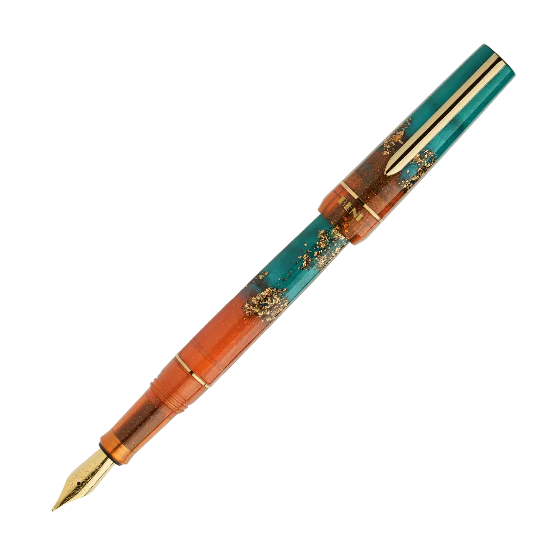 BENU presents the newest Haute Collection — a line of elegant, fashion-inspired pens that blend classic charm with bold, modern flair. The designs include both subtle and vibrant styles, showcasing BENU’s signature glitter and color artistry. Each pen features a faceted body with alternating wide and slender facets, complemented by either gold-plated or chrome-plated trims for a sleek, timeless look.

With a bold orange and teal body streaked with gold, Chic turns heads with runway-ready style. Fashion-forw